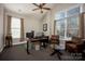 Home office with a live-edge desk, two chairs, and large windows at 19914 Wooden Tee Dr, Davidson, NC 28036