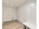 Bright laundry room with white walls and wood-look floors at 207 Faulkner St, Clover, SC 29710