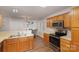 View of kitchen with double sink and oak cabinets at 2604 Cochrane Dr, Charlotte, NC 28269