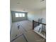 Large bonus room featuring natural light and wood railing on the staircase at 3240 Mcharney Dr # 36, Harrisburg, NC 28075