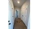 Hallway featuring white doors and black hardware and leading to a bedroom at 3240 Mcharney Dr # 36, Harrisburg, NC 28075