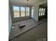 Bright living room with large windows overlooking a fire pit and backyard at 3240 Mcharney Dr # 36, Harrisburg, NC 28075