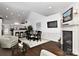 Open concept dining area with hardwood floors, fireplace, and kitchen views at 373 Battery Cir, Clover, SC 29710