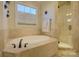 Relaxing bathroom with soaking tub and walk-in shower at 4010 Soleado Dr, Matthews, NC 28104