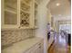 Butlers pantry with granite countertop and glass-front cabinets at 4010 Soleado Dr, Matthews, NC 28104