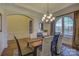 Formal dining room with hardwood floors, large windows, and a chandelier at 4010 Soleado Dr, Matthews, NC 28104