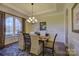 Spacious dining room with hardwood floors, large window, and chandelier at 4010 Soleado Dr, Matthews, NC 28104