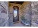 Inviting entryway with a wooden door and a welcoming bench at 4010 Soleado Dr, Matthews, NC 28104