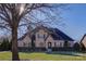 Beautiful two-story home with stone accents and a manicured lawn at 4010 Soleado Dr, Matthews, NC 28104