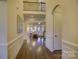 Grand two-story foyer with hardwood floors and elegant staircase at 4010 Soleado Dr, Matthews, NC 28104