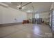 Spacious garage with epoxy flooring and ample storage at 4010 Soleado Dr, Matthews, NC 28104