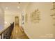 Bright hallway with hardwood floors and modern wall art at 4010 Soleado Dr, Matthews, NC 28104