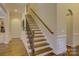 Elegant staircase with wrought iron railing and hardwood floors at 4010 Soleado Dr, Matthews, NC 28104