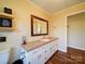 Bathroom with vanity and large mirror at 44743 Fish Camp Rd, New London, NC 28127