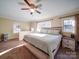 Main bedroom with ceiling fan, large windows, and a view of the backyard at 44743 Fish Camp Rd, New London, NC 28127