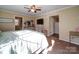 Main bedroom with ceiling fan, dresser, and access to a second room at 44743 Fish Camp Rd, New London, NC 28127