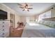 Main bedroom with ceiling fan, dresser, and large windows at 44743 Fish Camp Rd, New London, NC 28127