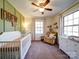 Bedroom with crib, rocker, and dresser at 44743 Fish Camp Rd, New London, NC 28127