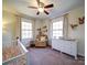 Bedroom with crib, rocker, and dresser at 44743 Fish Camp Rd, New London, NC 28127