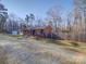 Brick ranch house with attached garage and gravel driveway at 44743 Fish Camp Rd, New London, NC 28127