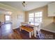 Kitchen with white cabinets, wood table, and window view at 44743 Fish Camp Rd, New London, NC 28127