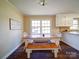 Kitchen features white cabinets and a farmhouse style table at 44743 Fish Camp Rd, New London, NC 28127