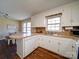 Kitchen features white cabinets, dishwasher, and an island with seating at 44743 Fish Camp Rd, New London, NC 28127