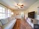 Open living room with hardwood floors, a couch, and a view of kitchen at 44743 Fish Camp Rd, New London, NC 28127