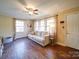 Living room featuring hardwood floors, large windows, and a cozy couch at 44743 Fish Camp Rd, New London, NC 28127