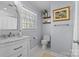 Updated bathroom with white vanity, marble countertop, and hexagon tile floor at 4526 Wedgewood Dr, Charlotte, NC 28210