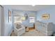 Bright and airy Bedroom with light blue walls and a crib at 4526 Wedgewood Dr, Charlotte, NC 28210