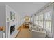 Elegant dining room featuring hardwood floors, a fireplace, and large windows at 4526 Wedgewood Dr, Charlotte, NC 28210