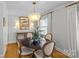 Bright dining area with a round table, four chairs, and a modern chandelier at 4526 Wedgewood Dr, Charlotte, NC 28210