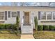 Inviting front entrance with a wooden door and white steps at 4526 Wedgewood Dr, Charlotte, NC 28210