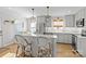 Modern kitchen with gray cabinets, quartz countertops, and breakfast bar at 4526 Wedgewood Dr, Charlotte, NC 28210