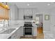 Modern kitchen with stainless steel appliances and white quartz countertops at 4526 Wedgewood Dr, Charlotte, NC 28210