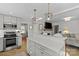 Open concept kitchen with island, stainless steel appliances, and white cabinetry at 4526 Wedgewood Dr, Charlotte, NC 28210