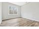 Bright bedroom with large window and hardwood floors at 4827 Eaves Ln, Charlotte, NC 28215