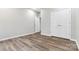 Simple bedroom with hardwood floors and double door closet at 4827 Eaves Ln, Charlotte, NC 28215