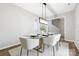 Bright dining area with glass table and modern light fixture at 4827 Eaves Ln, Charlotte, NC 28215