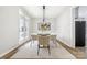 Elegant dining room with glass table and modern chandelier at 4827 Eaves Ln, Charlotte, NC 28215