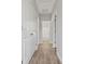 Long hallway with doors to bedrooms and bathrooms at 4827 Eaves Ln, Charlotte, NC 28215