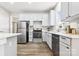 Modern kitchen with stainless steel appliances and white cabinets at 4827 Eaves Ln, Charlotte, NC 28215