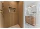 Stylish bathroom with a textured shower wall and modern vanity with gold fixtures at 5113 Grice Ct, Charlotte, NC 28210