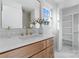 Updated bathroom features warm wood vanity with stone counters and modern fixtures at 5113 Grice Ct, Charlotte, NC 28210