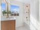 Bathroom with white tile, gold fixtures, bathtub, and natural light from a large window at 5113 Grice Ct, Charlotte, NC 28210