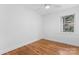 Bright bedroom featuring hardwood floors, white trim, and one window at 5113 Grice Ct, Charlotte, NC 28210