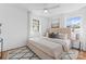 Bedroom with a tufted headboard bed, neutral bedding, and natural light at 5113 Grice Ct, Charlotte, NC 28210