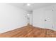 Bright bedroom featuring hardwood floors, white trim, and a single closet door at 5113 Grice Ct, Charlotte, NC 28210