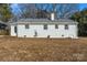 Side view of a renovated white brick house with a spacious backyard at 5113 Grice Ct, Charlotte, NC 28210